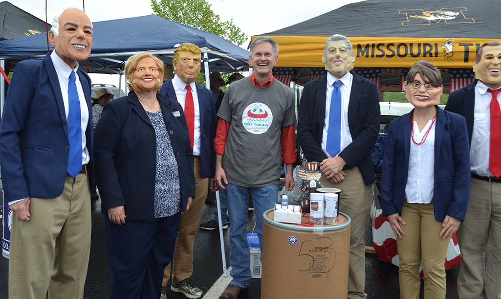The Food Bank Board Member Michael Kateman poses with EDI's "Ship of Fools" team members dressed as candidates and politicians. 
