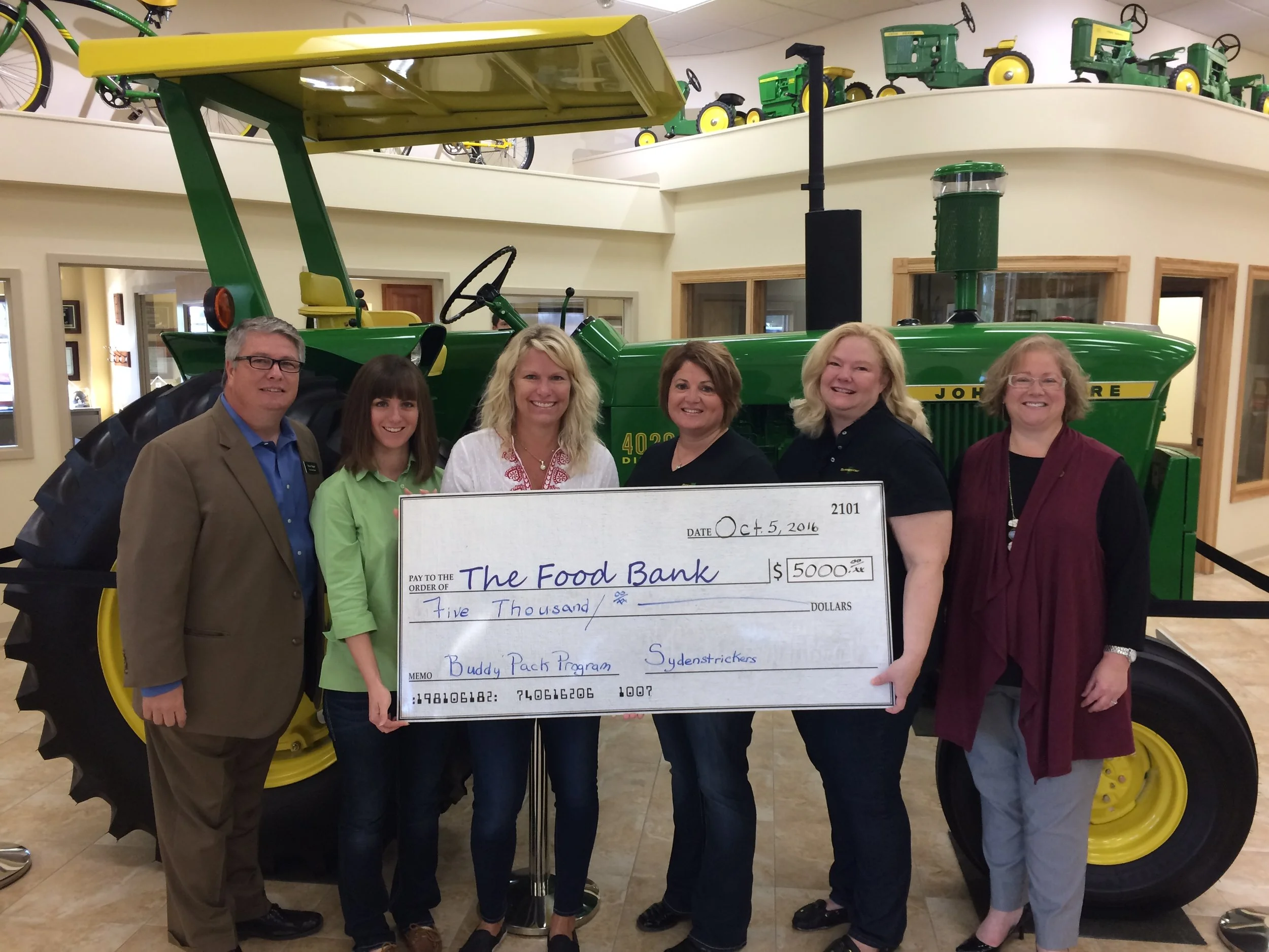 Pictured, from left, are Steve Yager with The Food Bank, Millicent Dawdy, Lee Ann Sydenstricker, Nicole Fleak and Kim Sydenstricker, all with the company, and Susan Dublin with The Food Bank.
