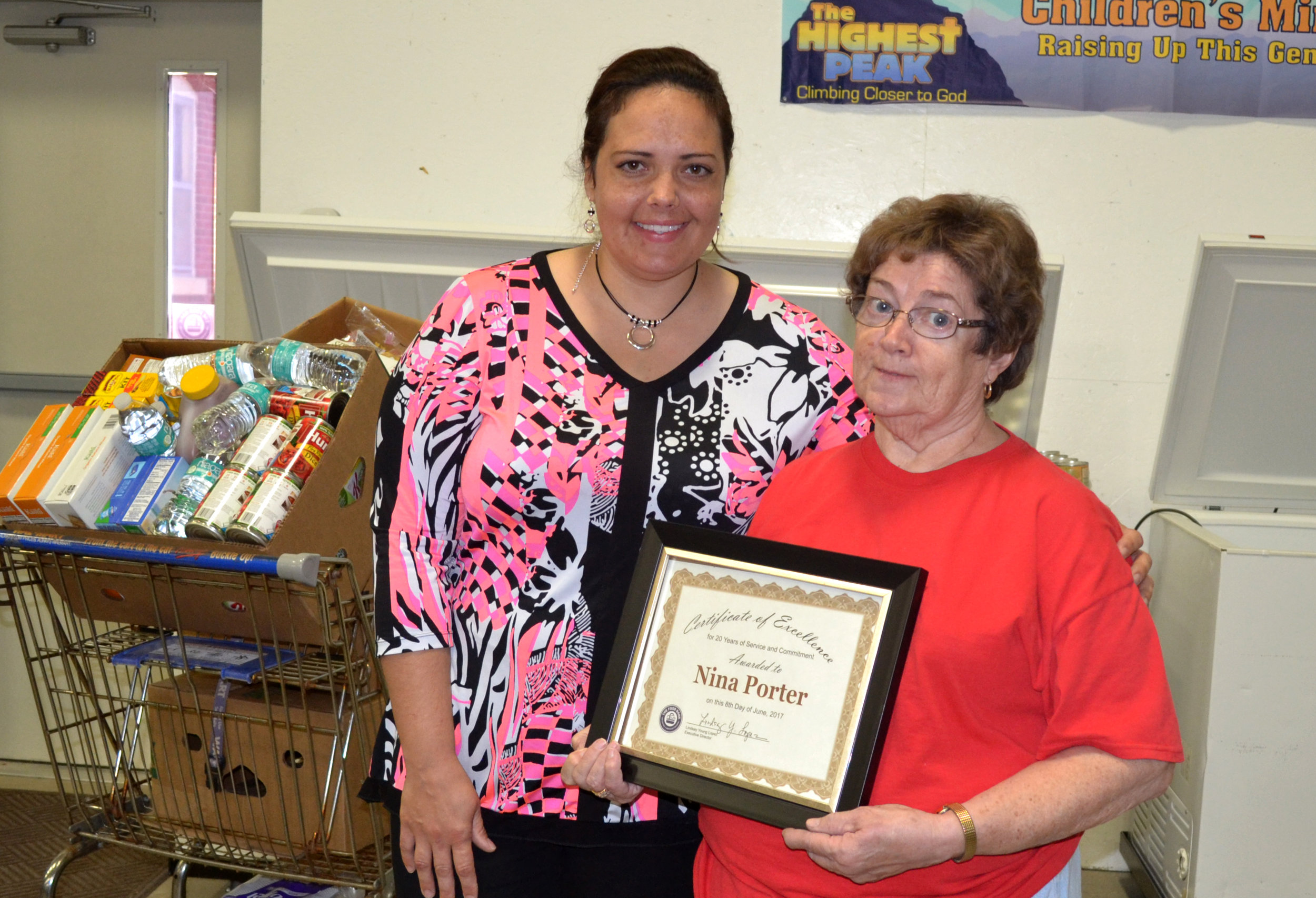 The Food Bank Agency Relations Coordinator Barbara Borntrager honors longtime Lewis County Food Pantry director Nina Porter. The pantry will continue next month at a new location in Canton.