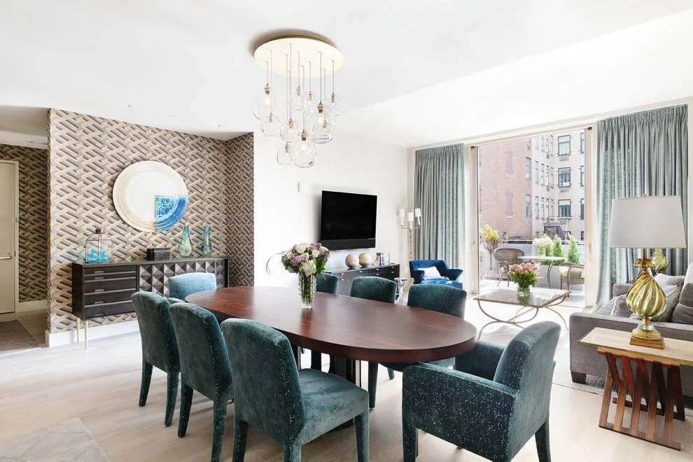 Here you can see the adjoining dining area with vintage Harvey Probber dining table and John Hutton for Donghia dining chairs reupholstered in a rich textured velvet. The chandelier is by John Pomp with hand-blown glass globes. The vintage sideboard and mirror complete this part of the room. The graphic wallpaper creates a separation in the space and sets the tone for the apartment when you step off the elevator.