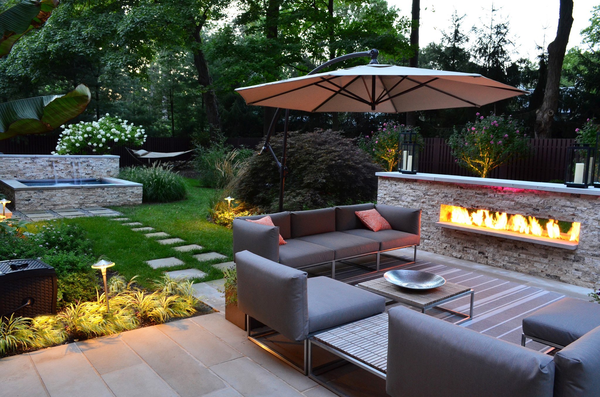 exterior-patio-landscaping-witching-design-ideas-of-backyard-landscaping-with-stone-garden-path-also-green-grass-and-rectangle-shape-pond-waterfall-concrete-floor-gray-color-outdoor-sofas-fireplace-wh.jpg