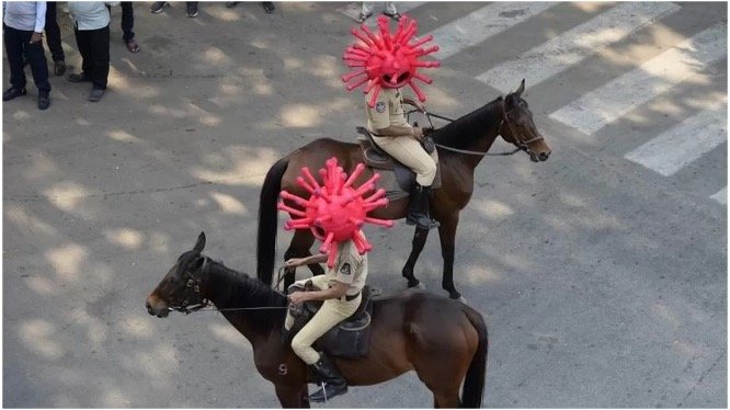 26. Virus-themed headwear on officials in India.jpg