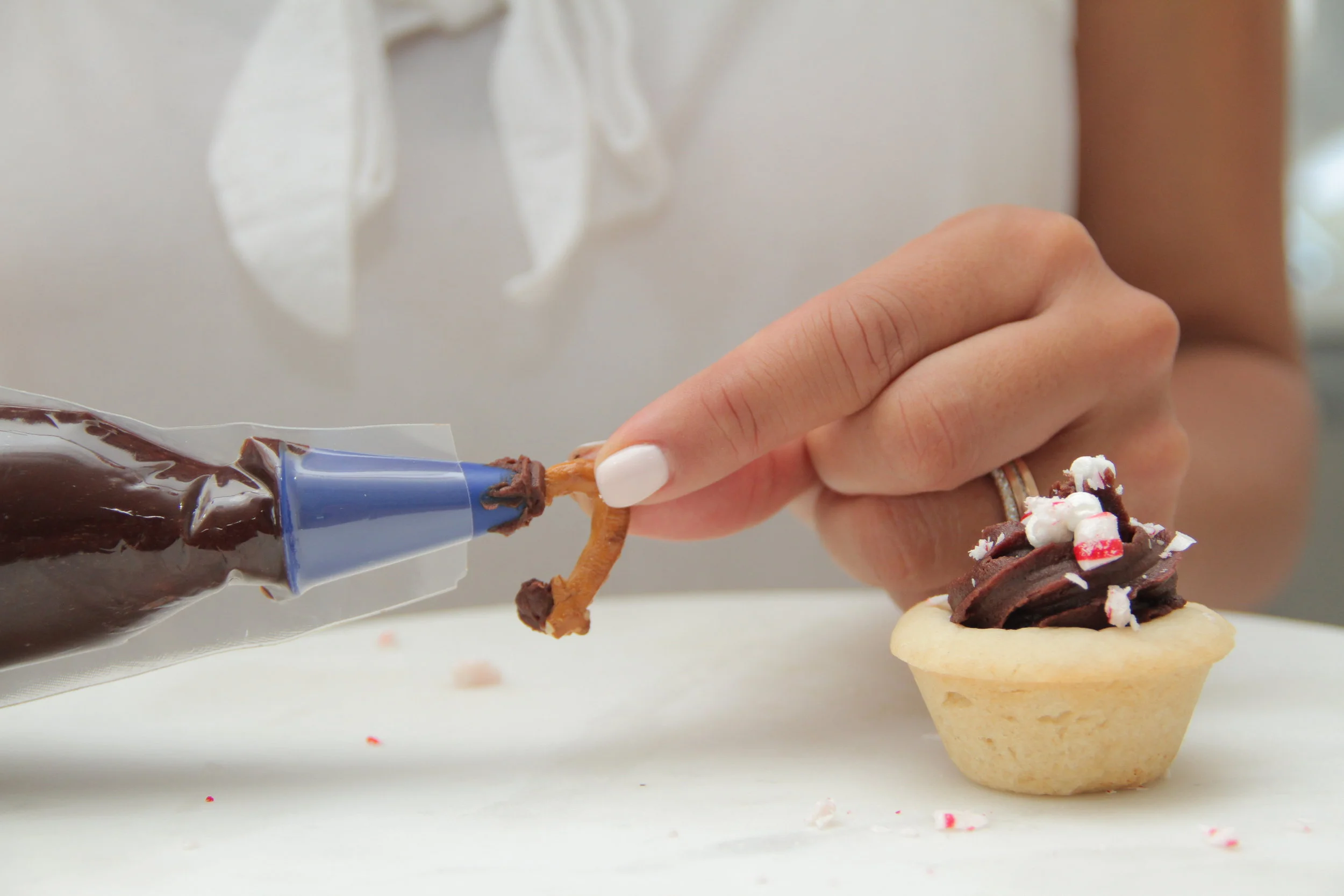 Add your pretzel handle using chocolate frosting