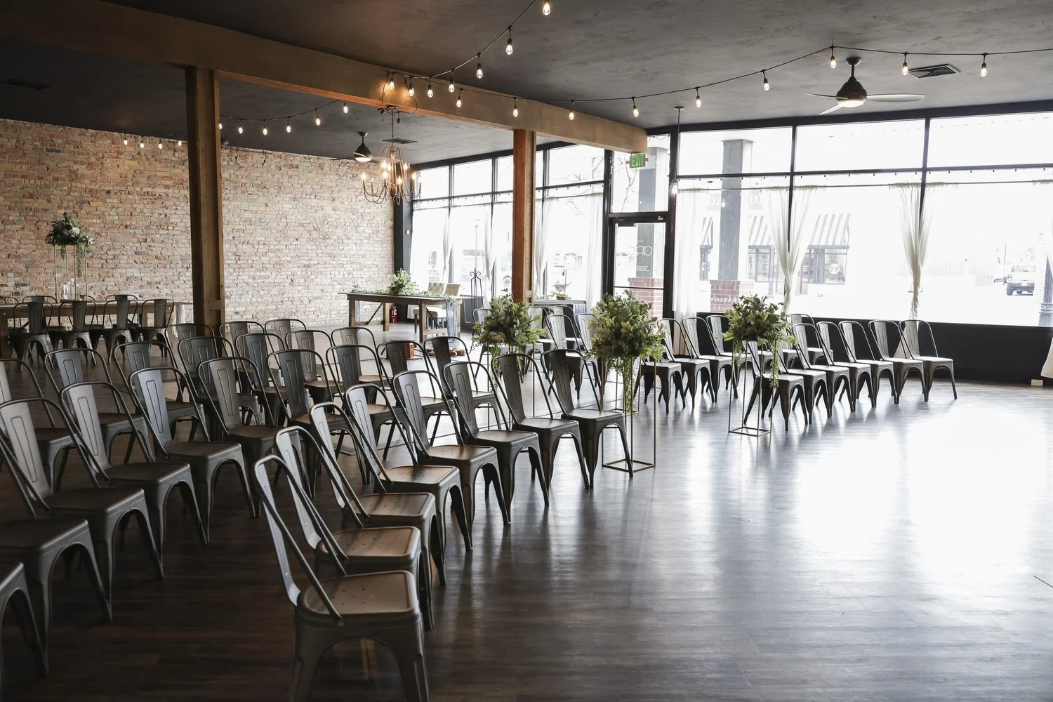 Brick & Main event hall in Rigby, Idaho with exposed brick wall and wooden tables
