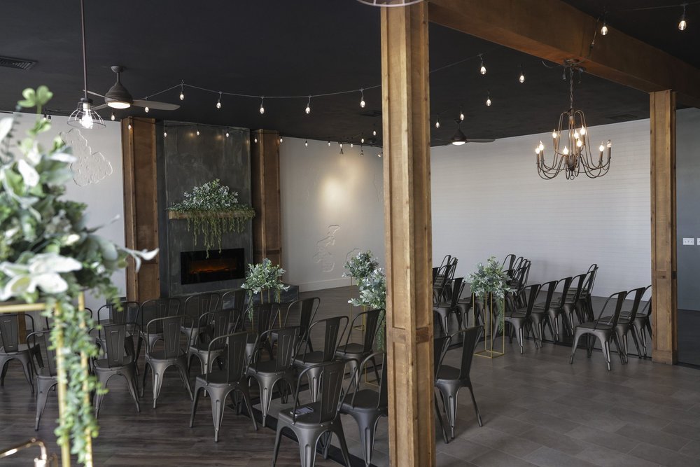 Event seating and wooden tables inside Brick & Main