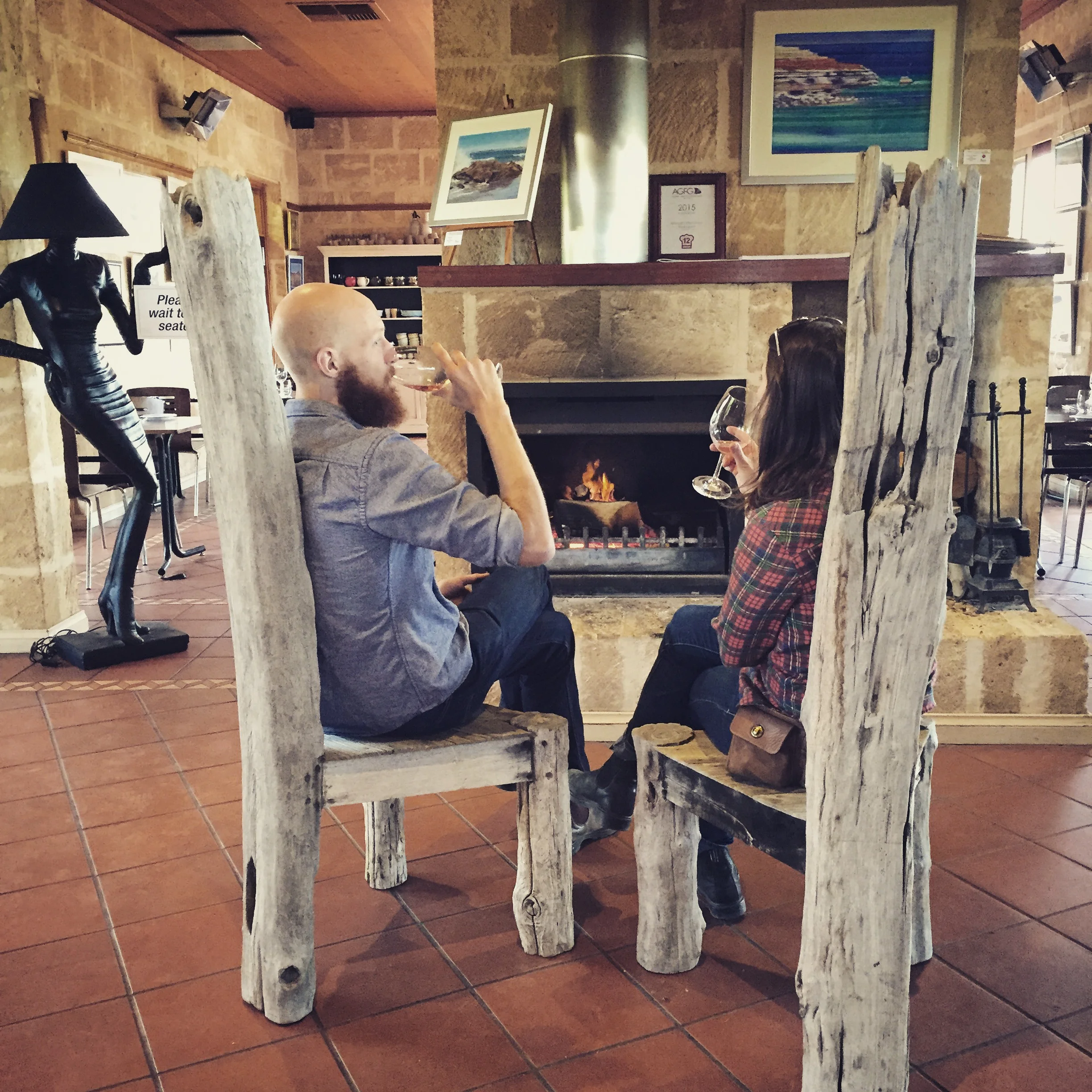 Randall & Kim sipping wine by the fire at Maxwells Winery. 