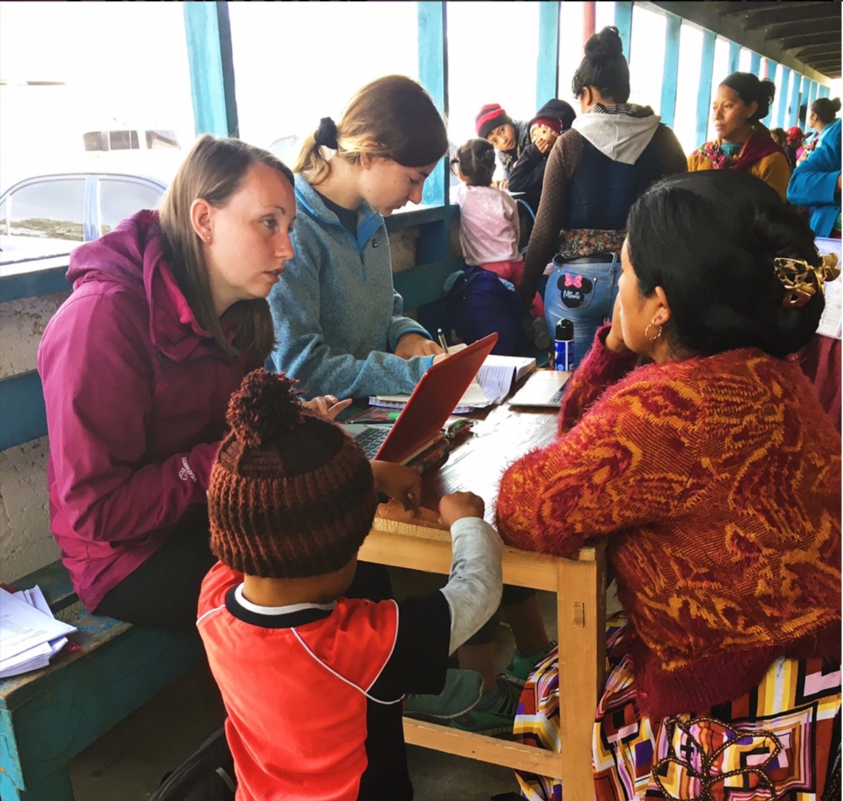 Volunteers Lauren Lambert and Bethan Crisp conducting reproductive health surveys with beneficiaries of the Nutrition Recuperation Program at a medical fair.