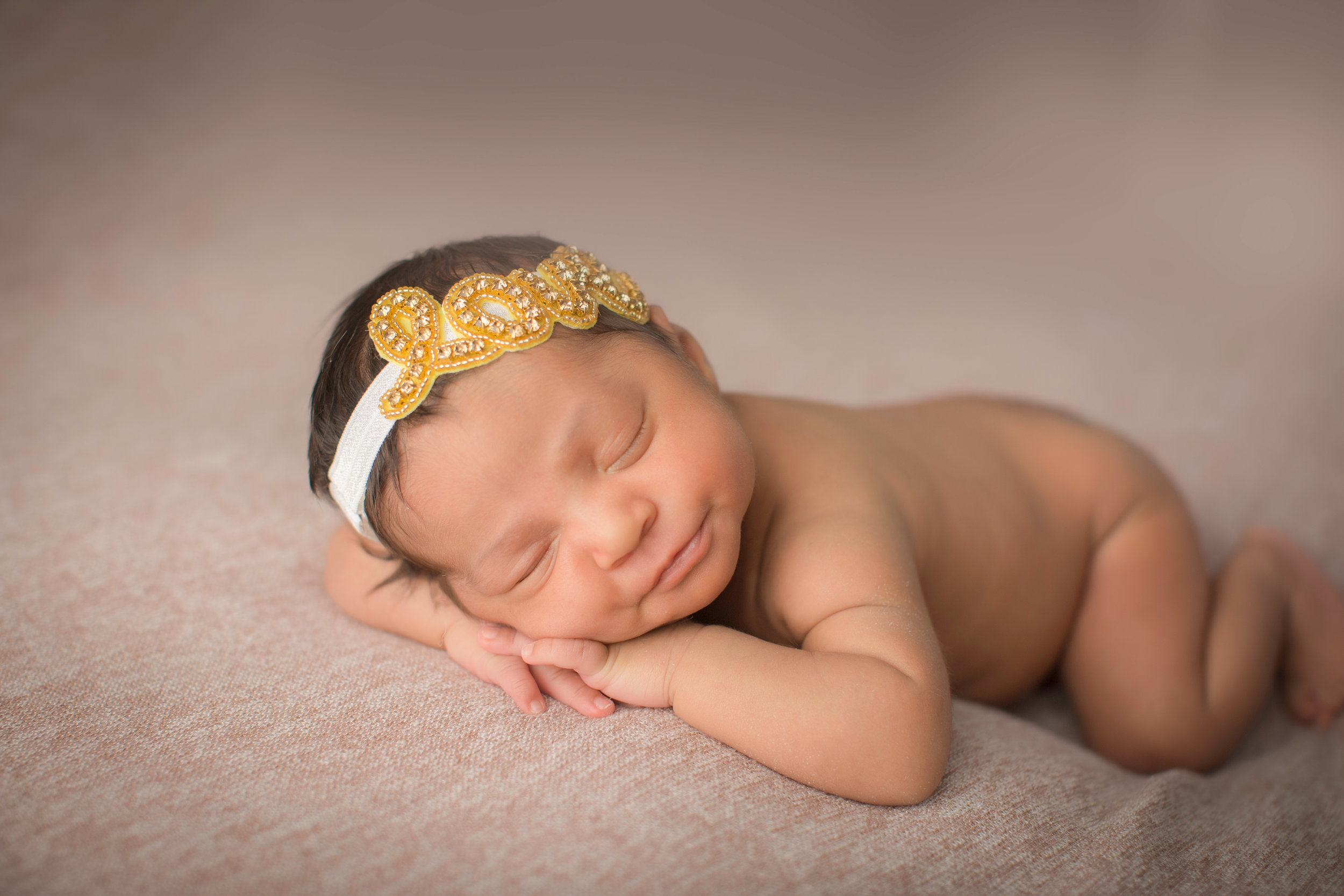  smiling baby with a cute love headband posing for cute baby photos 