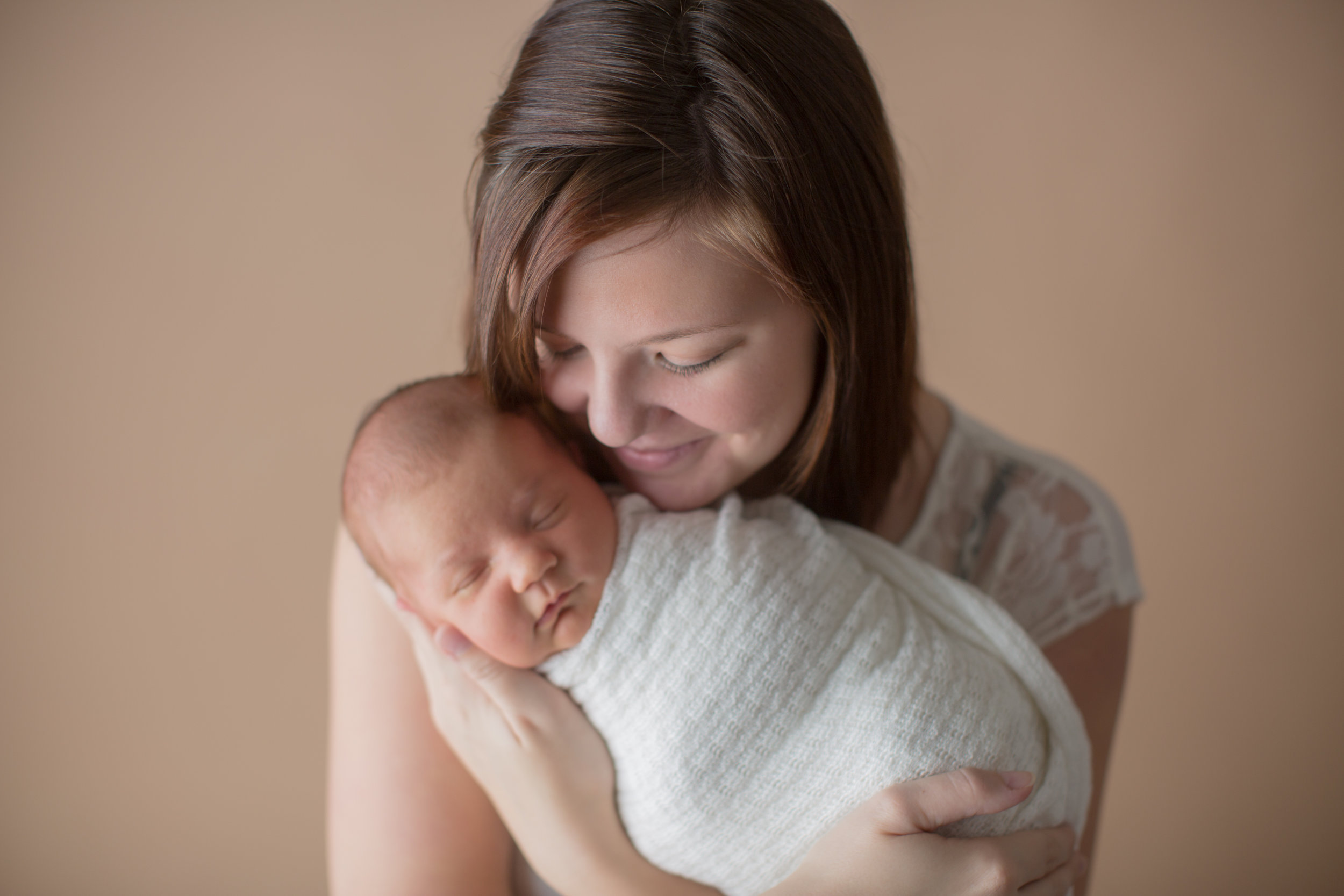  baby photography ideas with mom holding baby in a white wrap 