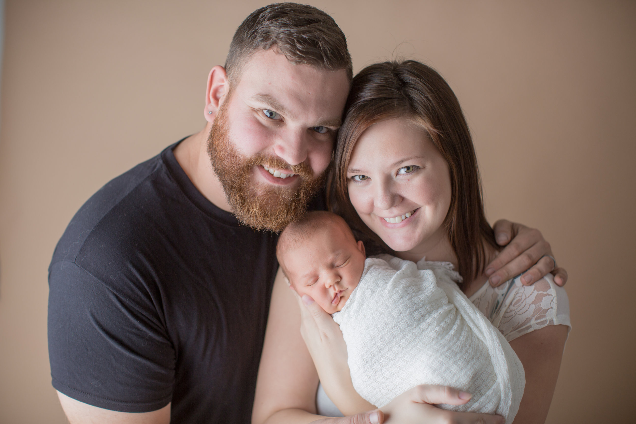  top photographer in fenton michigan capturing family portraits with newborn baby 