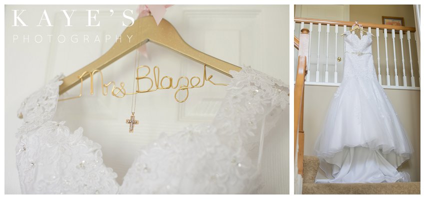 Wedding gown on personalized hanger with neckless hanging from banister in Flint Michigan