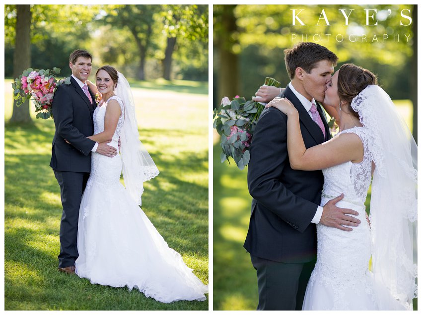 Bride and Groom kissing and posing in the grass in Flint Michigan at their wedding
