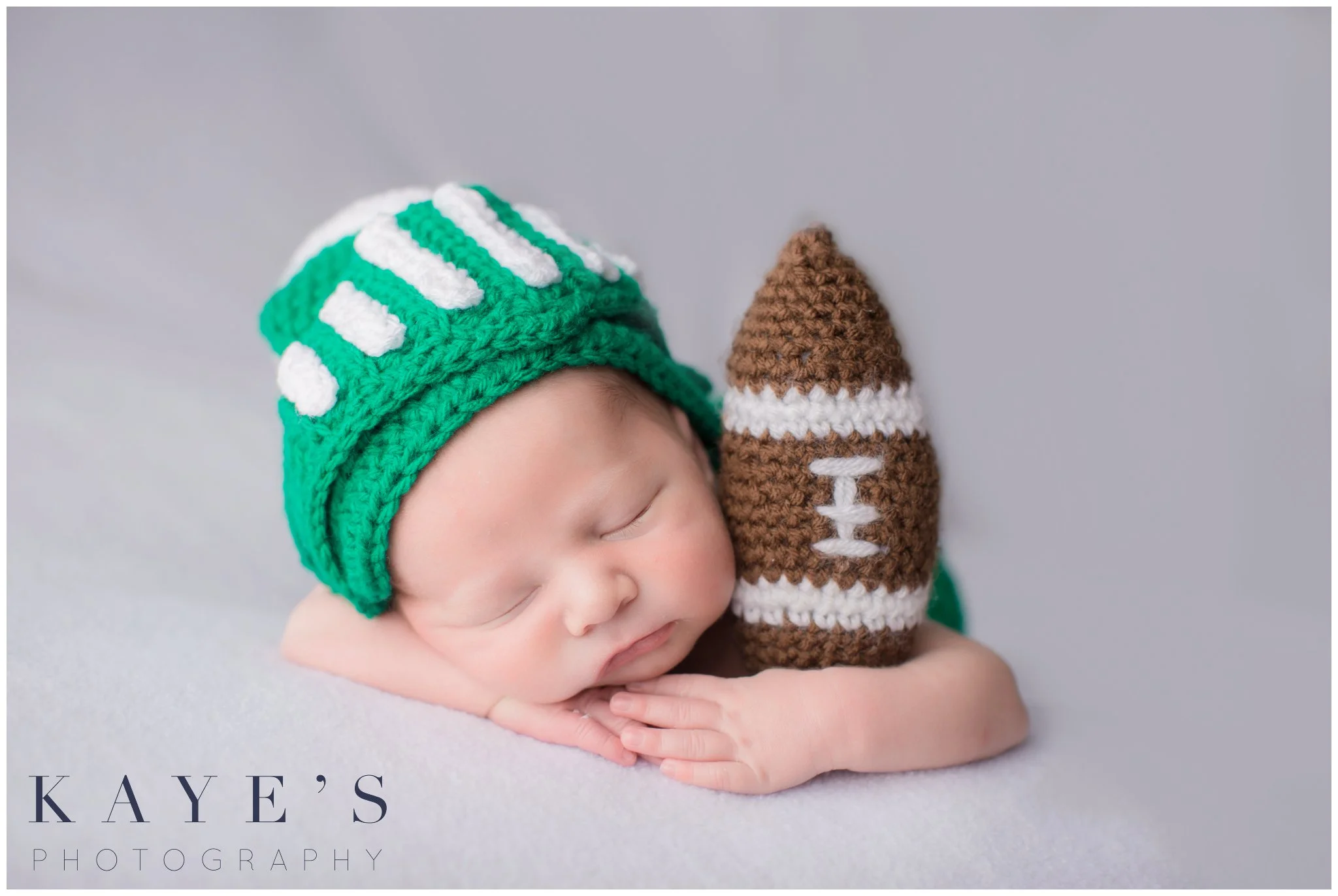 baby boy in michigan state gear holding a knit football