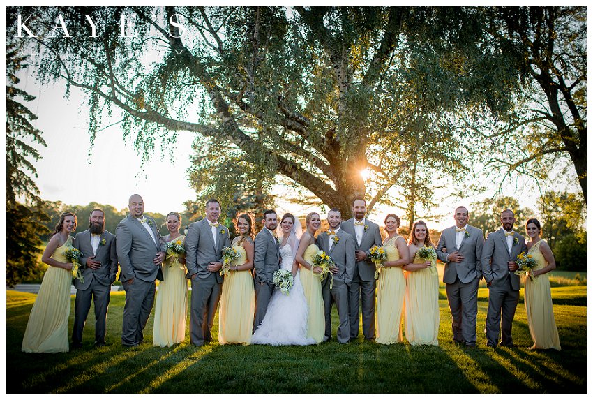 whole bridal party in couples with bride and groom during wedding day portraits at the lazy j ranch