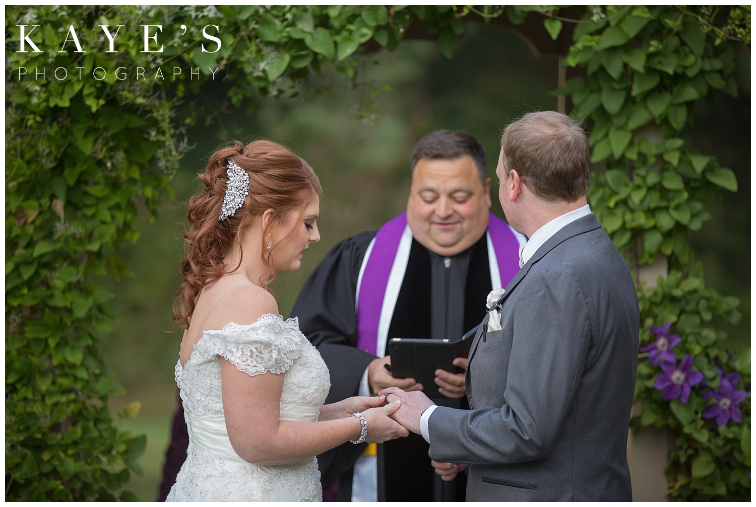 bride putting grooms ring in detroit michigan wedding
