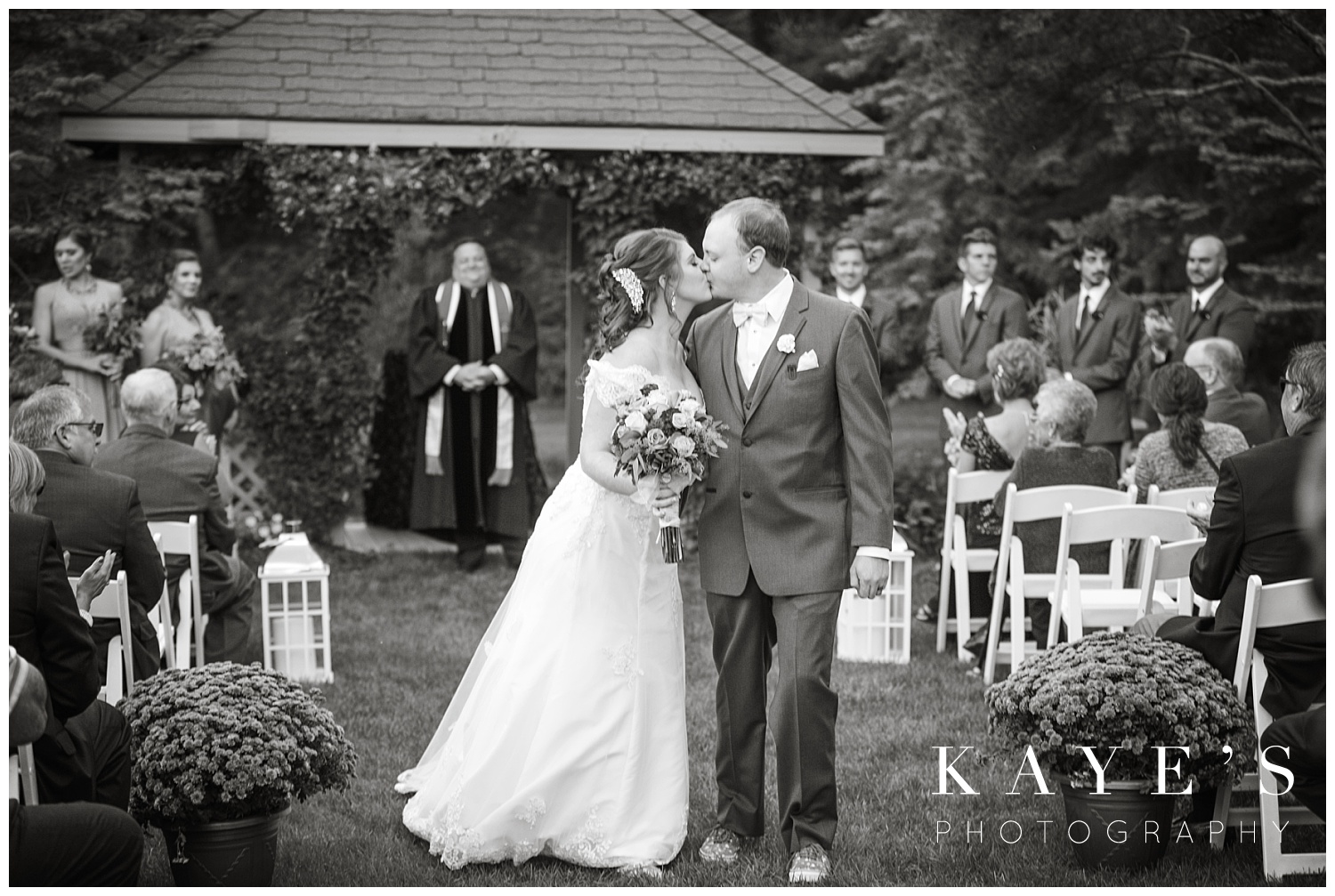 bride and groom kissing in aisle in detroit michigan