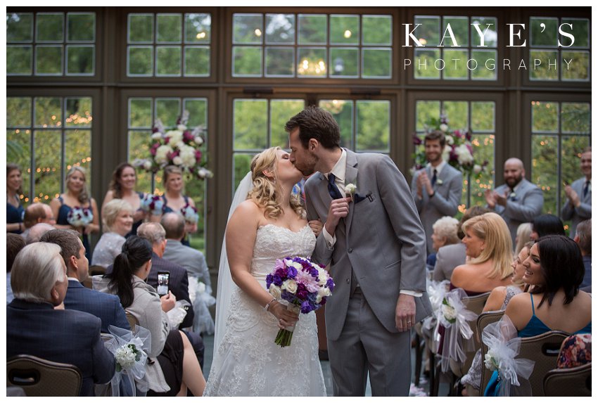 Bride and groom kissing after ceremony on wedding day at royal park hotel