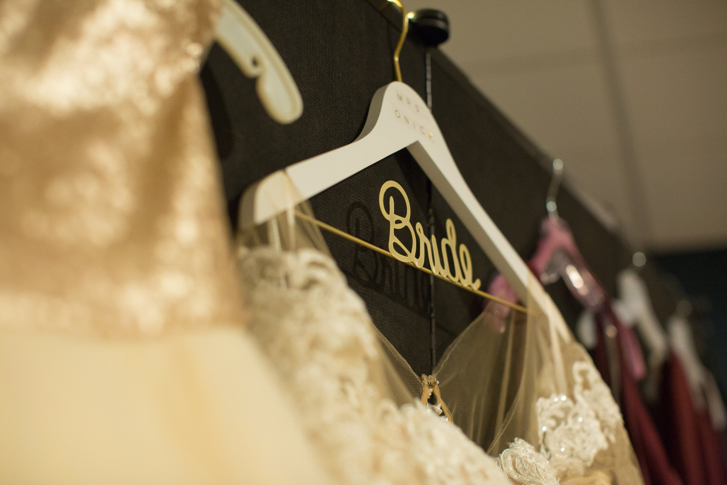 bride's dress hanging before ceremony in a Detroit, Michigan wedding with Kaye's Photography