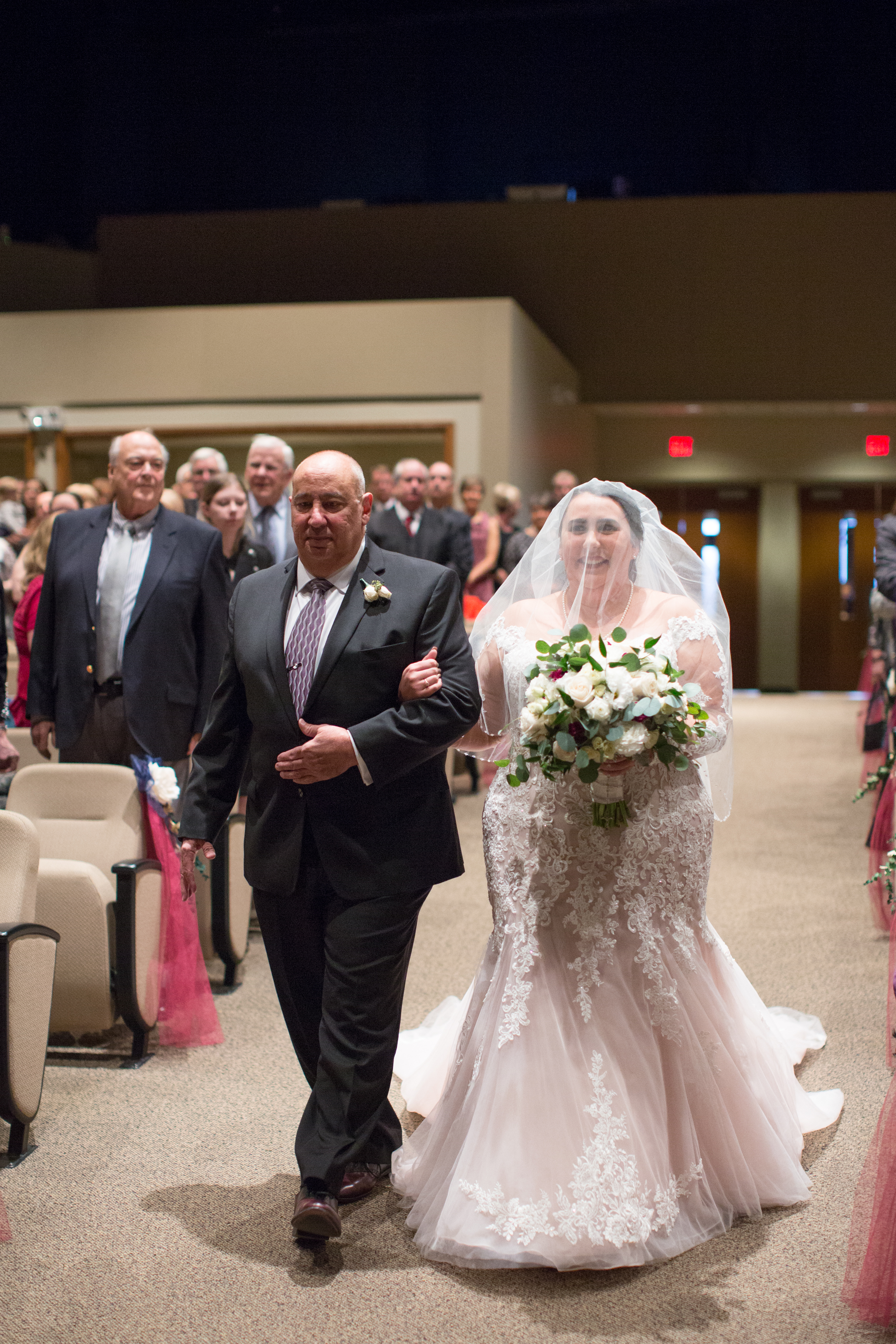 bride coming down the aisle during wedding ceremony in detroit, Michigan