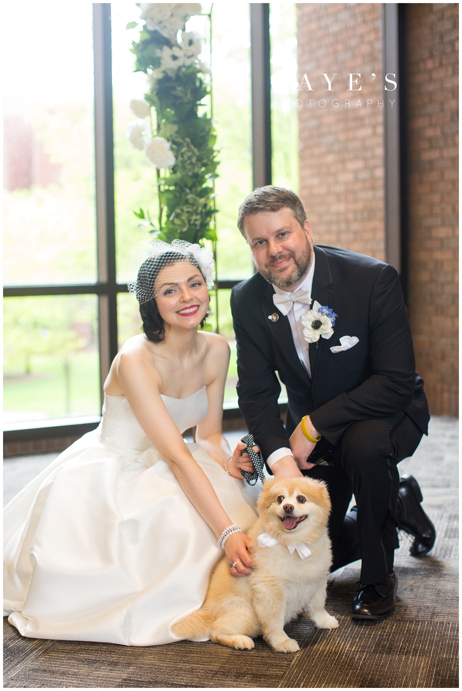 bride and groom with dog during wedding photos after the wedding ceremony