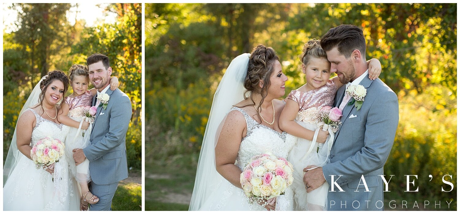 bride and groom with daughter on wedding day in grand blanc michigan