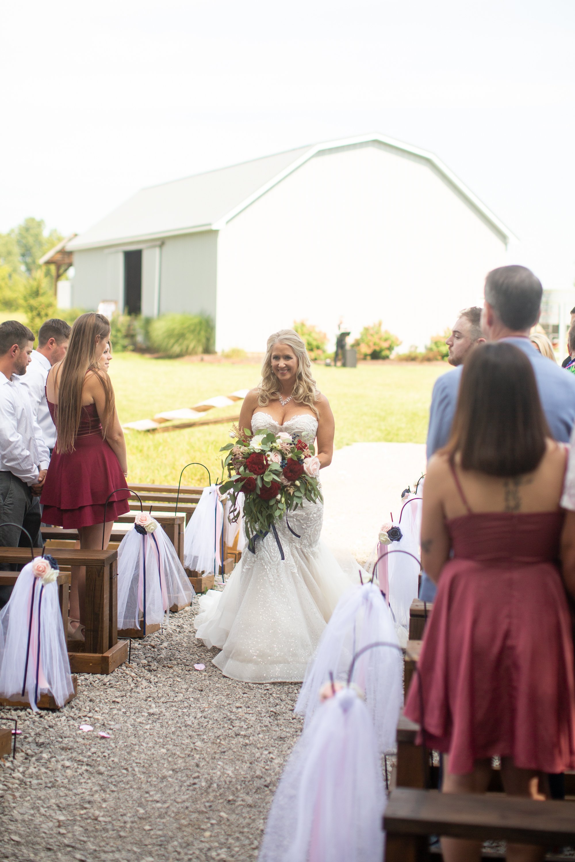 bride coming down aisle at  Meadow wood acres in morrice, michigan