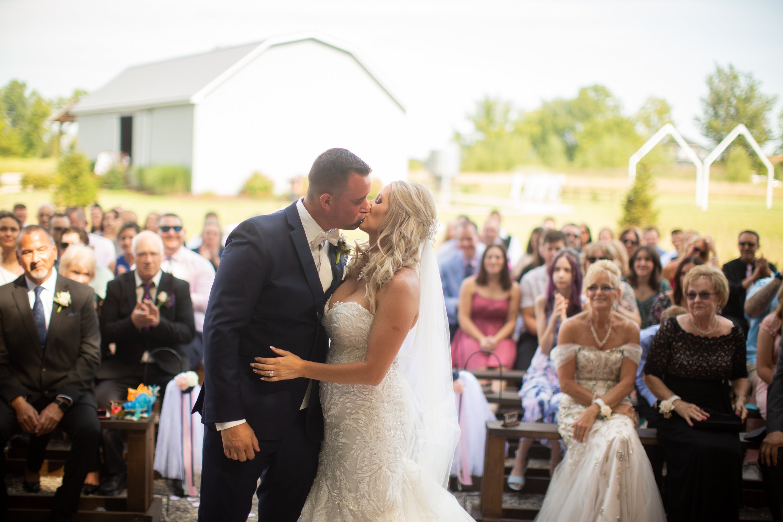 Bride and groom's first kiss at  Meadow wood acres in morrice, michigan