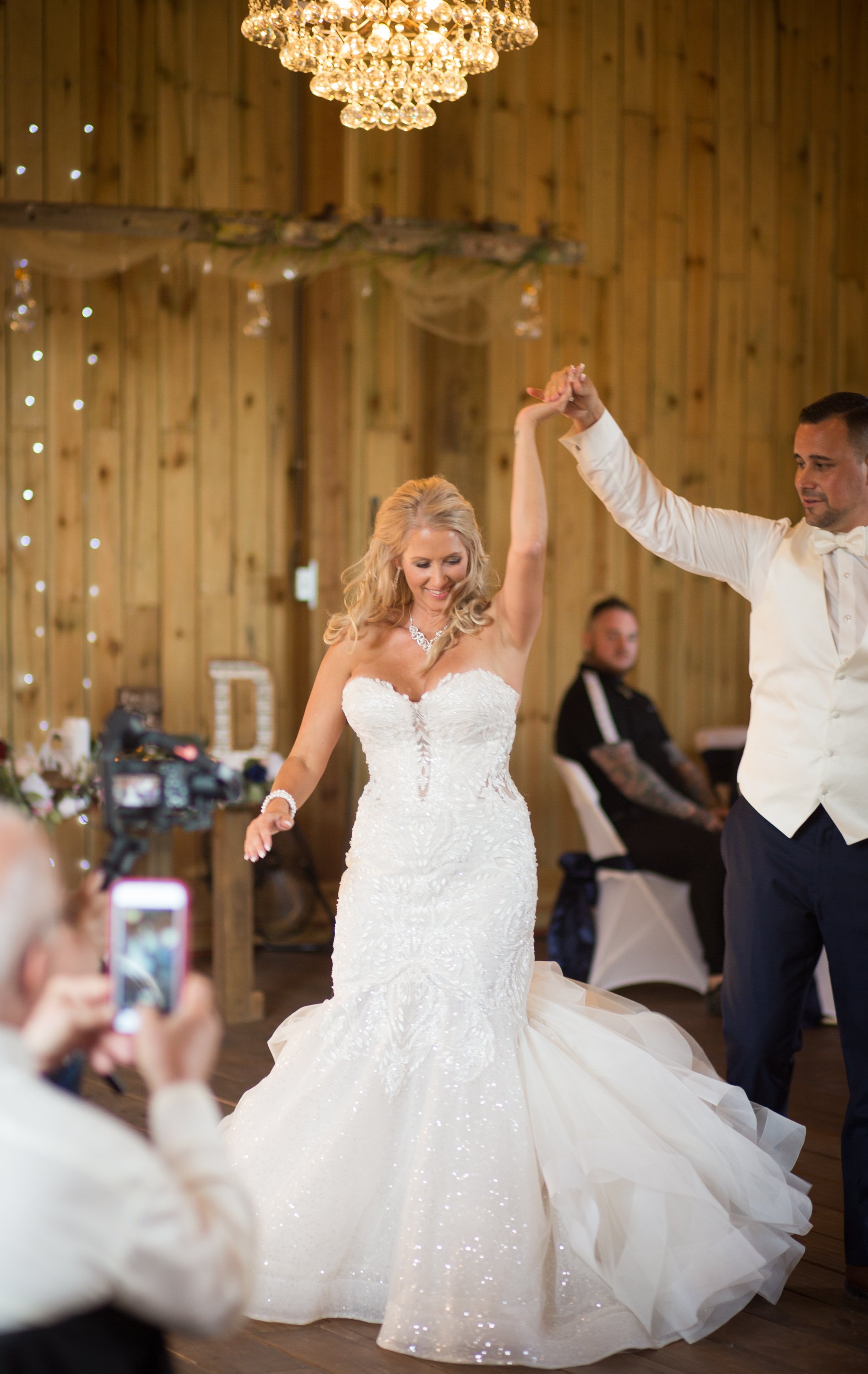 bride getting turned during first dance at meadow wood acres for michigan wedding