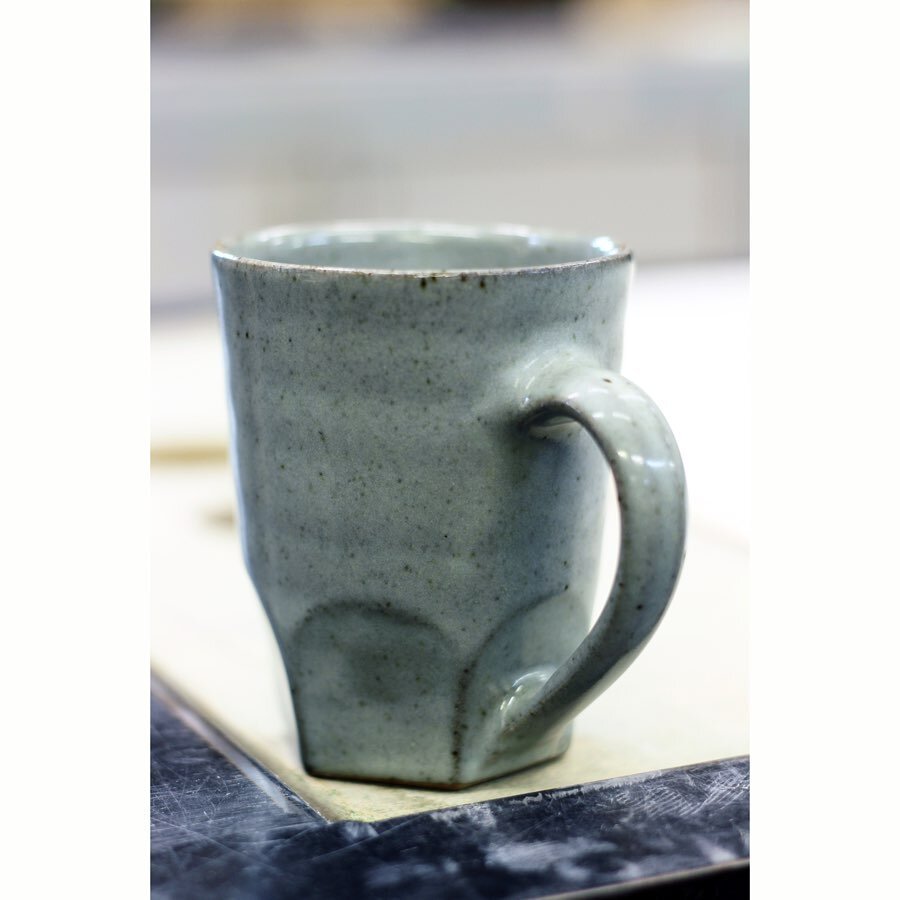 Made in a different clay than usual. The body is much higher in iron giving flecks throughout the surface in different sizes. It has a much more natural look other the forced speckled clays. 
The way the glaze breaks on the edges adds depth to the gl