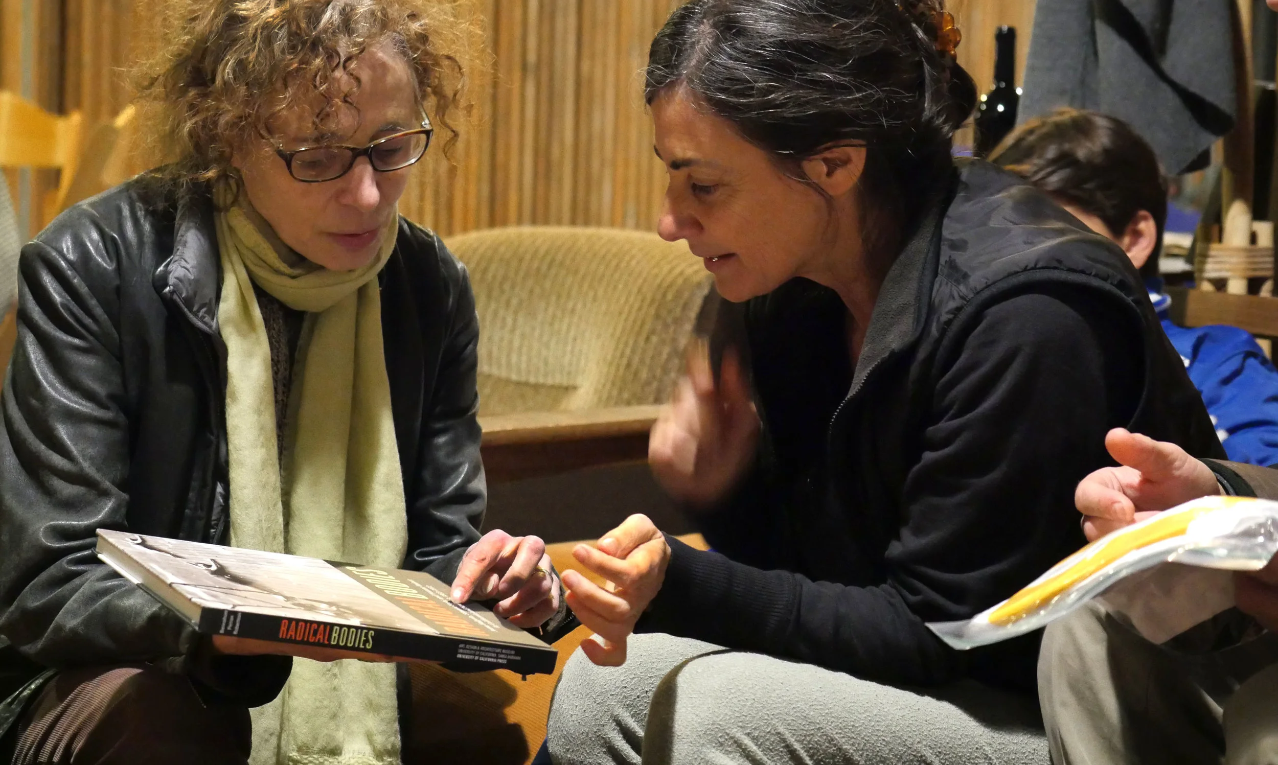 I'm showing Noa Wertheim the book I co-wrote on Anna Halprin, whom she had worked with. Photo by Cari Ann Shim Sham