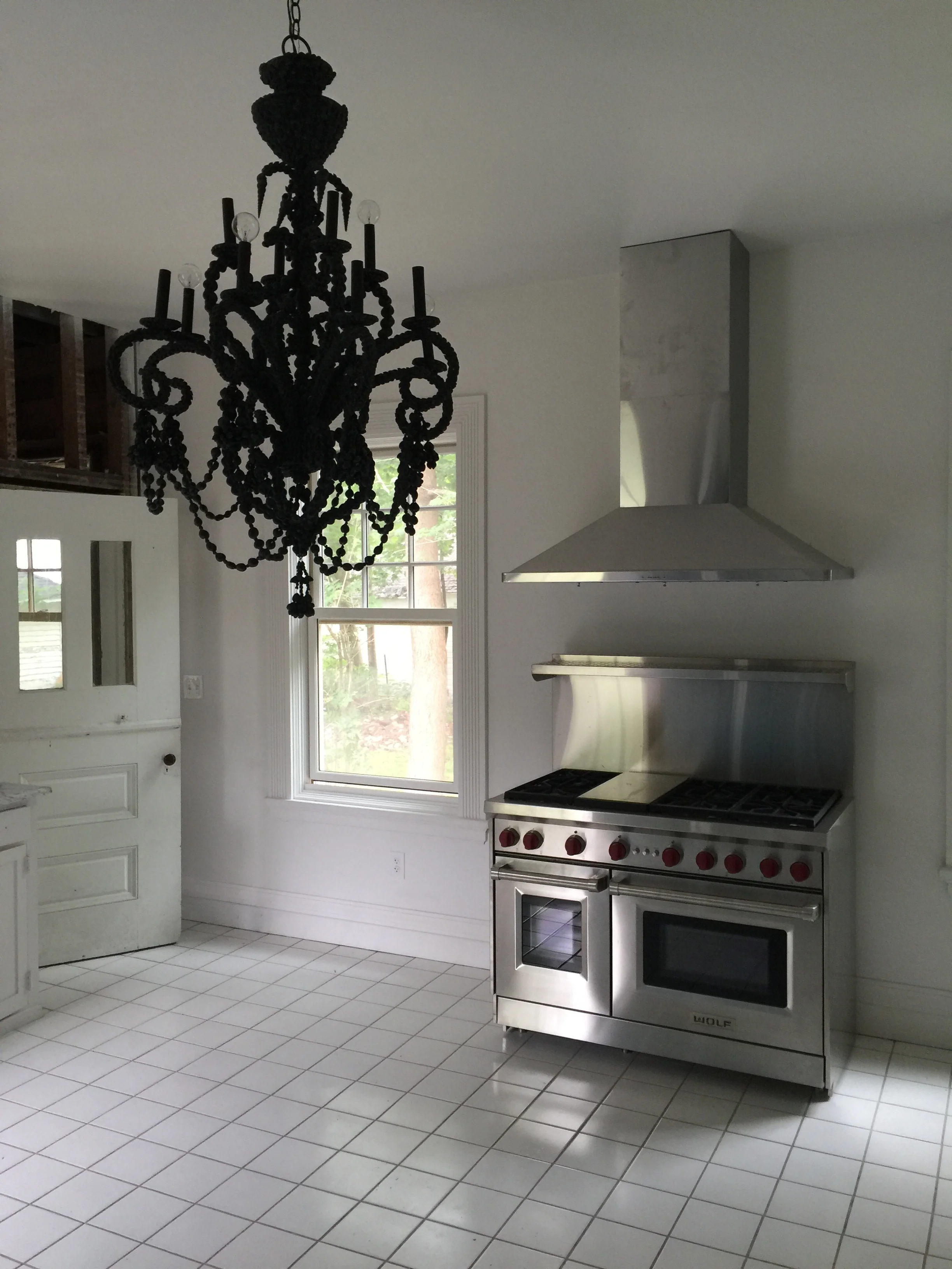 The spacious kitchen, equip with modern appliances like the new Wolf Range stove pictured here, is designed for family-style cooking. We’re excited to put it to use.