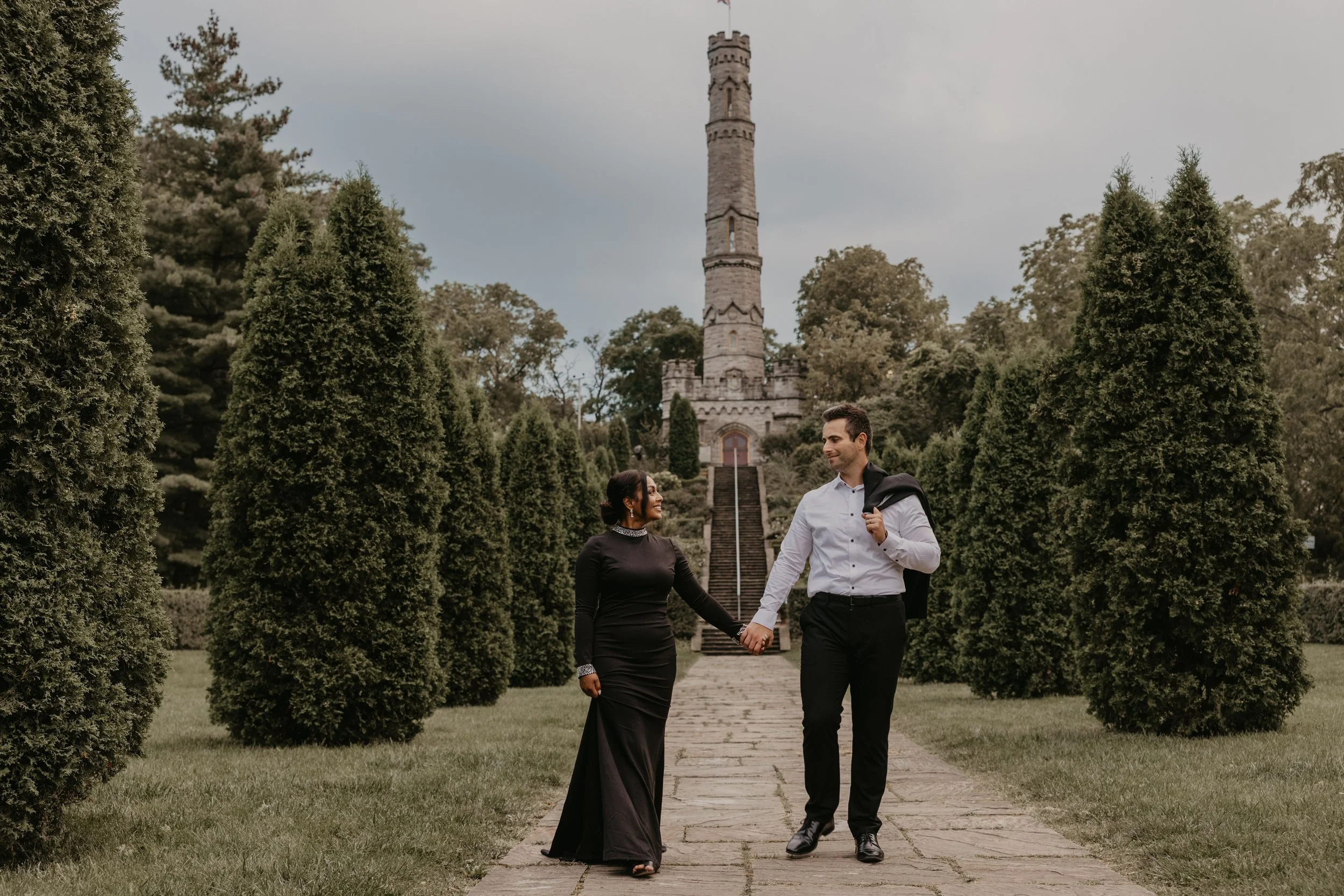 A man holding a baby and kissing them on the forehead in a hospital hallway.