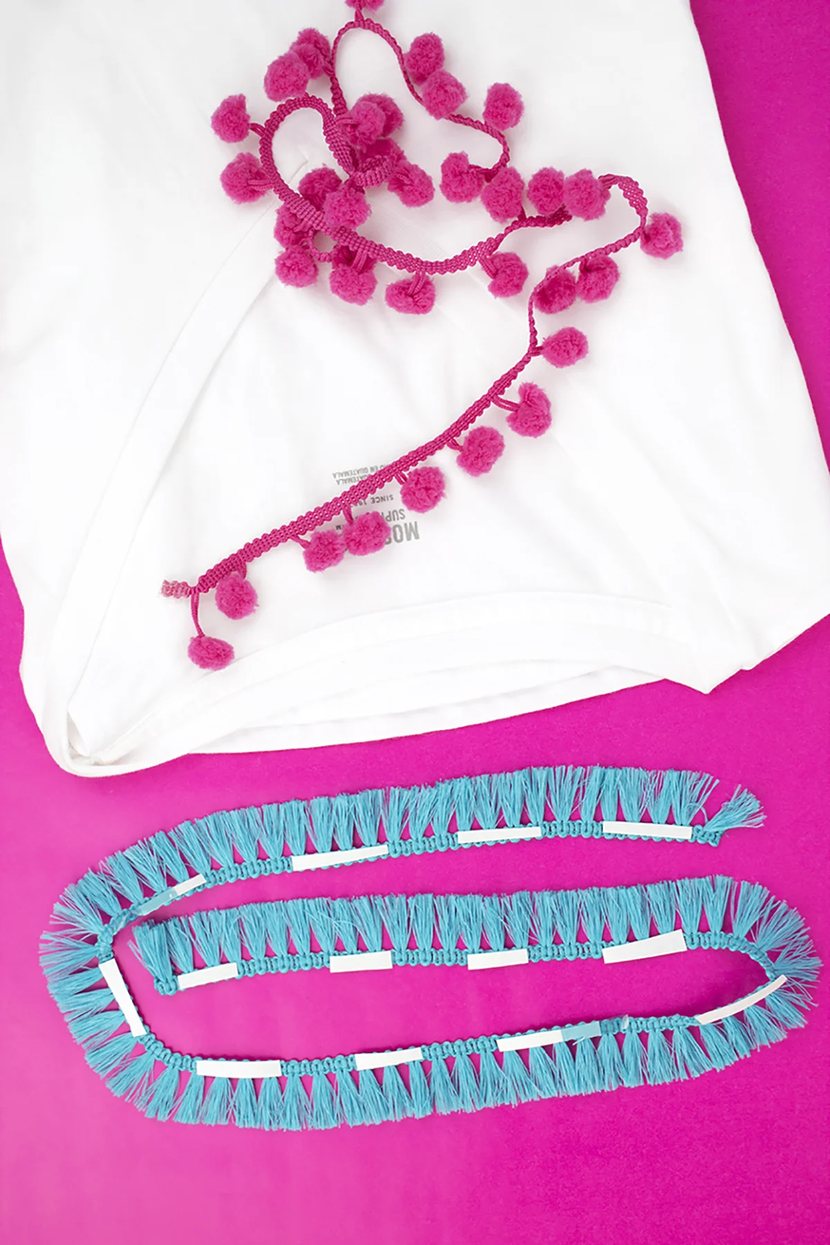 T-shirts are my go-to fashion choice, because of how easy and versatile they are. This no-sew embellished t-shirt features some of our favorite things- tees, tassels, and pom pom trim! #diytshirtideas #diytshirtnosew #tshirtmakeover