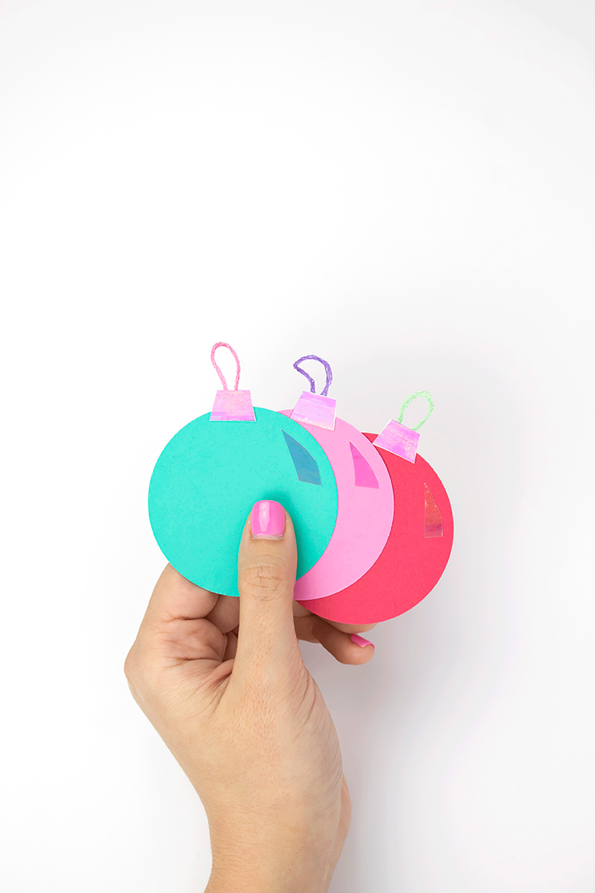 The iridescent effect on these ornaments is super 90’s, while also being modern. Holographic items are coming back! Give them to all your friends who love the 90’s as much as you do! Click for the DIY. #diychristmasornaments #diygifttags#diychristmascrafts