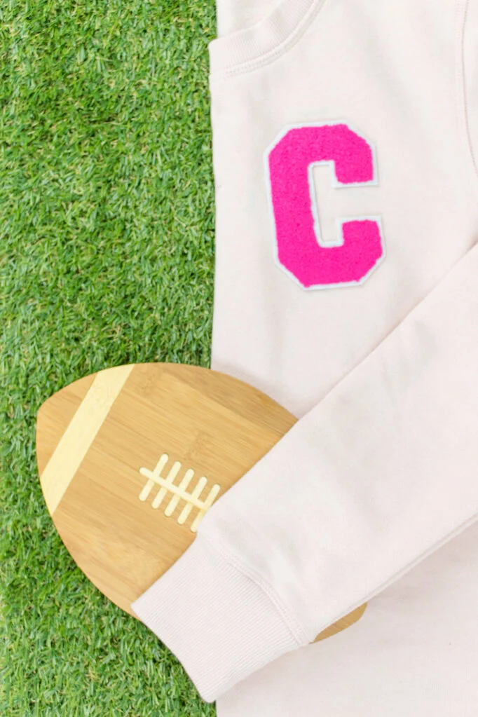 Maybe it’s because of all the back-to-school stuff or the fact that it’s fall, but suddenly I want nothing more than a cozy sweater with a cute fluffy letter on it. This varsity sweater is really easy to make- so easy, it almost isn’t a DIY! Click for the directions plus links so you can make your own! #varsitysweatshirt #varsitysweateroutfit #diyvarsitysweater