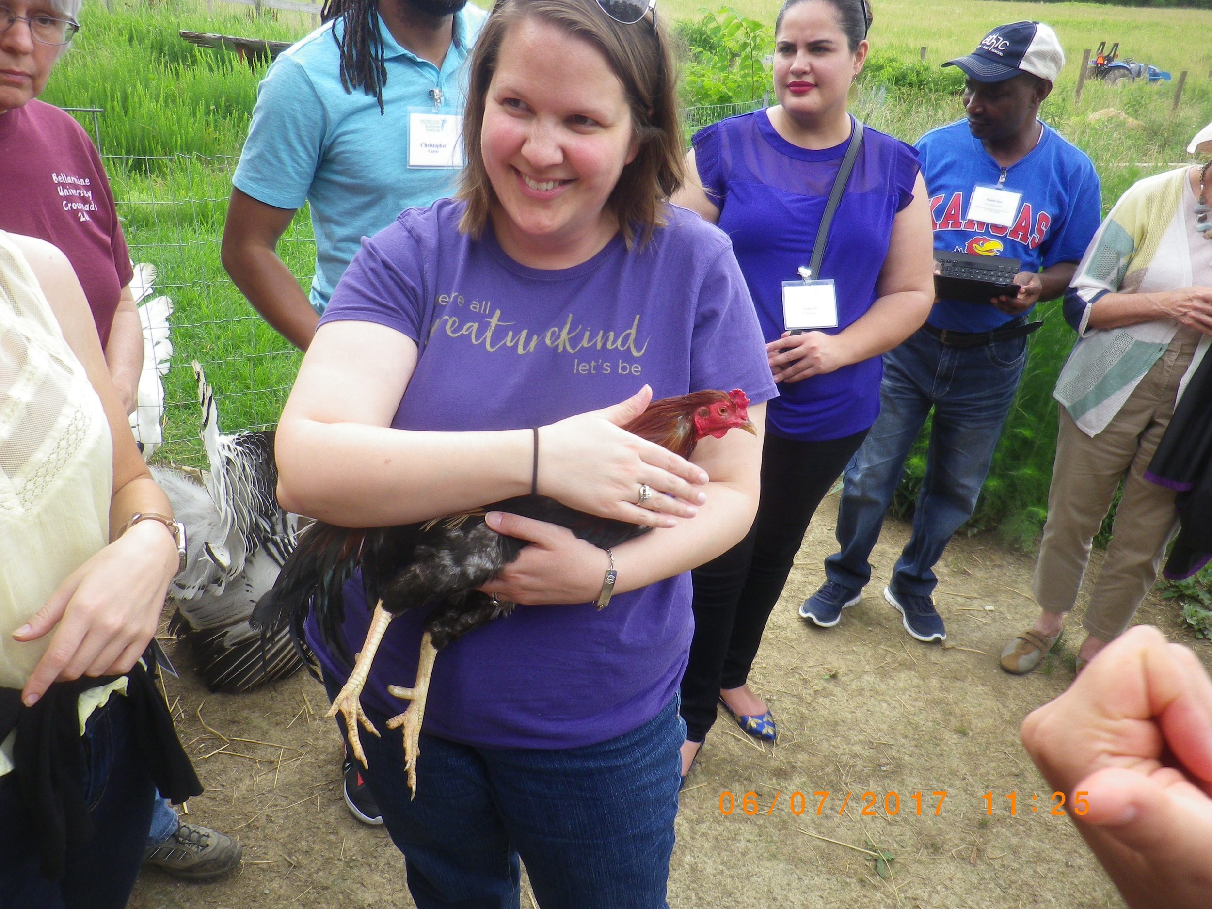 Sarah cradling Charleston the rooster, who loved to have his face massaged. He fell asleep in my arms! Photo by Blue.