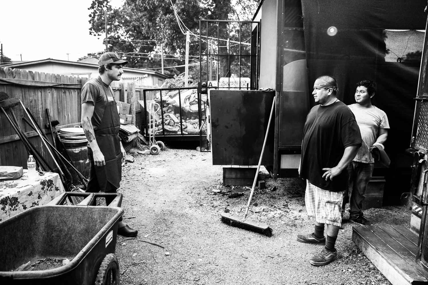  Francisco discusses the morning's shift switch plans with his co-workers. La Barbecue, 14 May 2016, Austin, TX. 