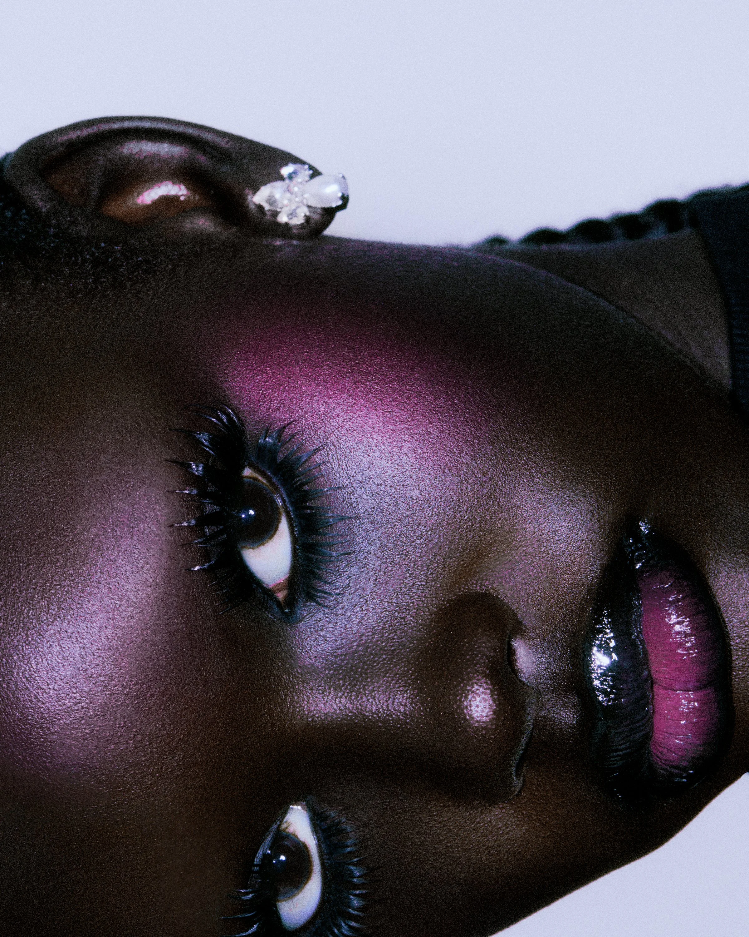 new york beauty photographer los angeles cosmetic photography makeup fashion pink eyeshadow deep dark skin skincare earrings lashes eyelashes top photographers
