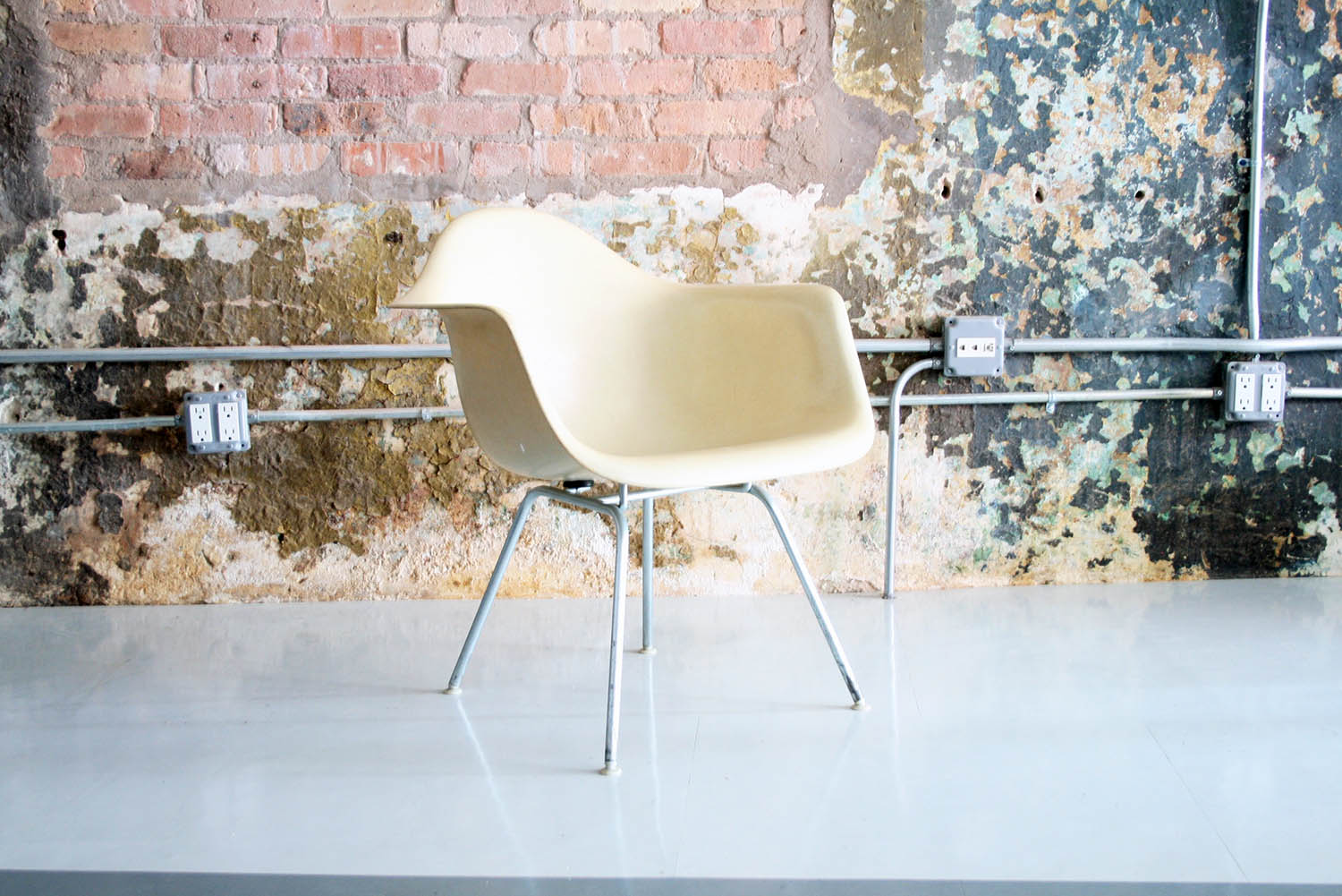 eames arm shell chair in parchment color on low H-base — CIRCA MODERN