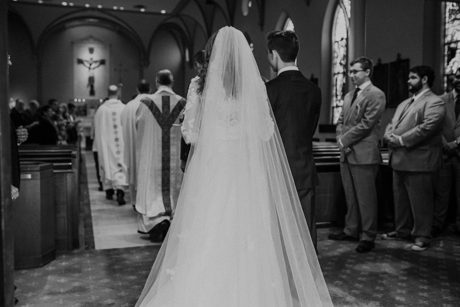 catholic wedding procession of bride and groom into church