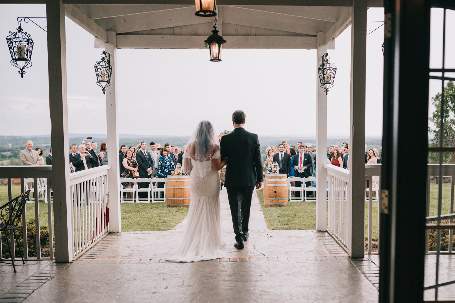 bride and father walk down the aisle at the stables at bluemont vineyard