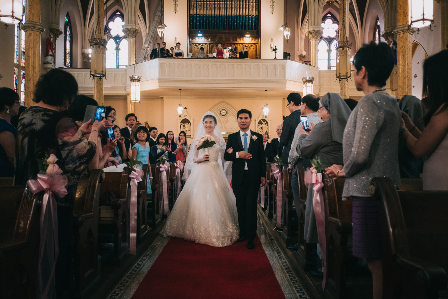 Bride walking down the aisle at St Mary Mother of God Catholic Church