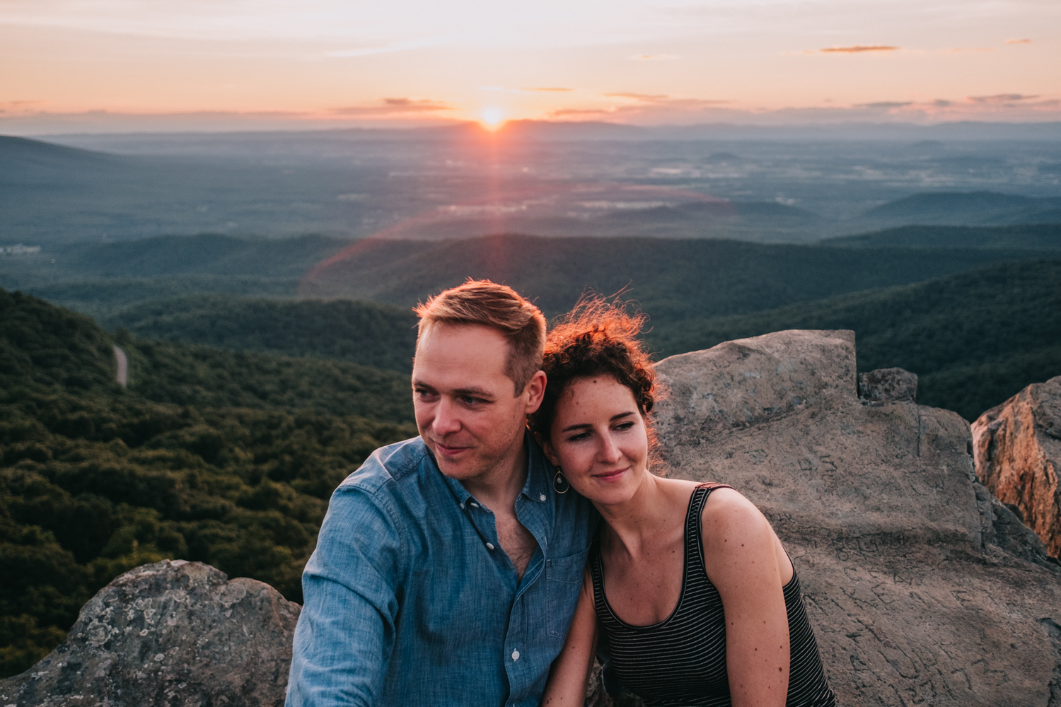 cuddling couple at sunset in the shenandoah mountains national parks