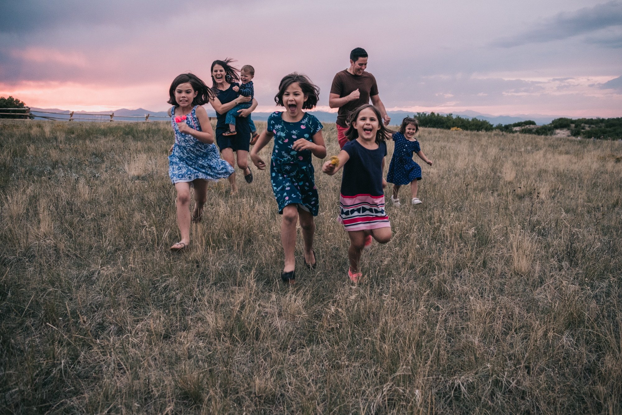 Colorado family portrait lifestyle session family running across a field