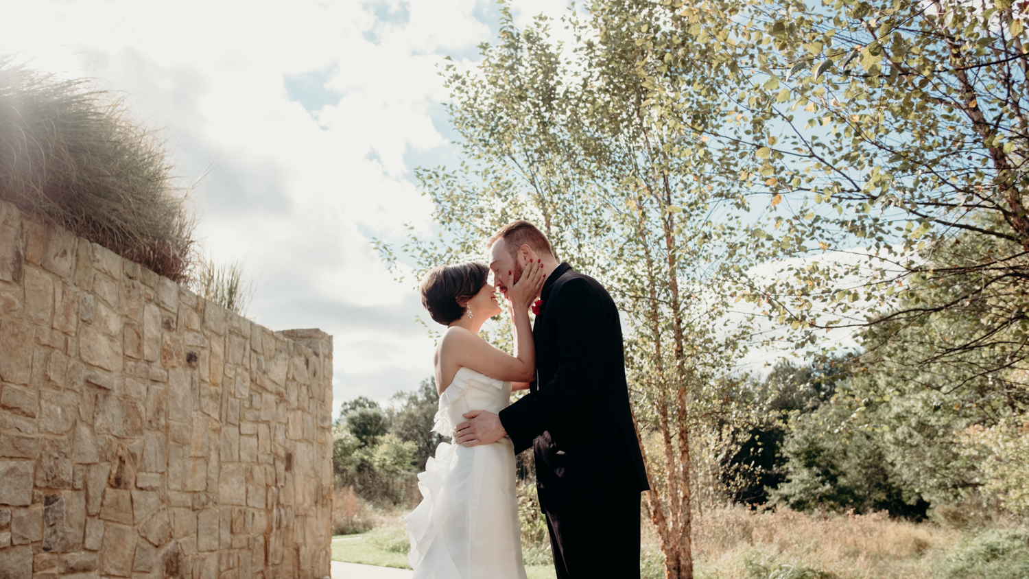 bride and groom kiss during first look at middleburg wedding