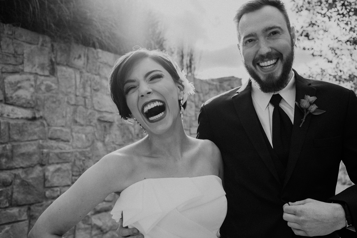 bride and groom laugh during their first look at classy Virginia wedding