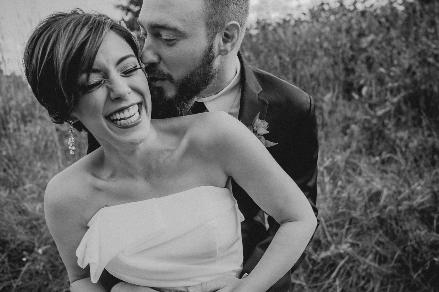 groom kisses his bride during emotional first look