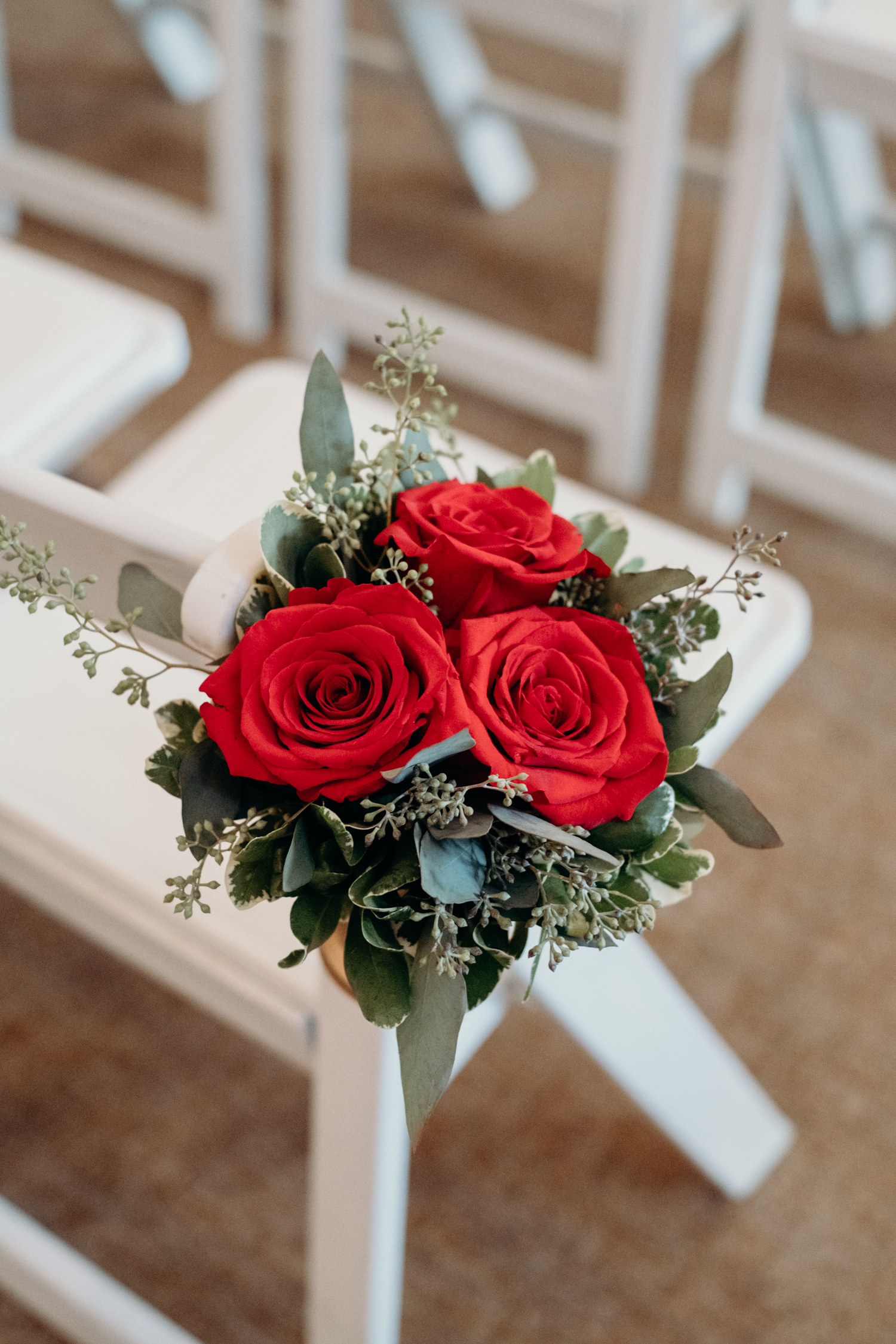 floral arrangement on ceremony chairs at middleburg wedding