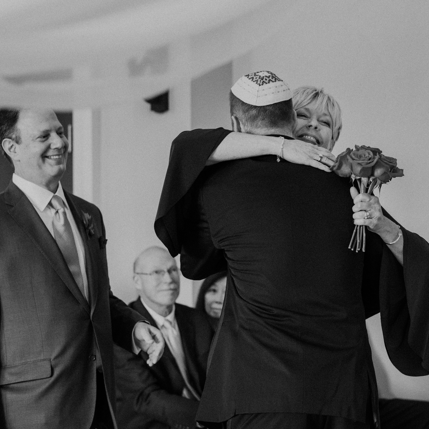 Mother hugs the groom at start of middleburg wedding ceremony