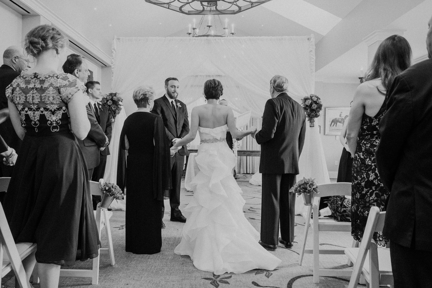 Bride's mother and Uncle hand bride off to the groom at start of wedding